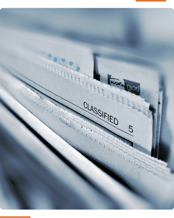 Close-up of a stack of papers, with the top paper labeled "CLASSIFIED" and numbered "5." The edges of the papers are visible, suggesting they are in a filing system.